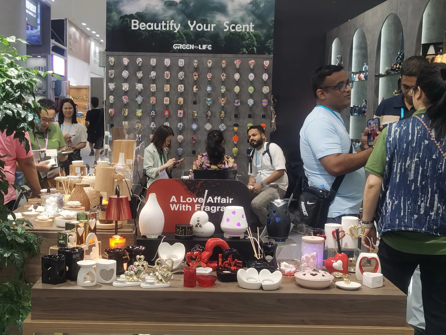 Green-Life aroma wares manufacturer showcasing latest OEM diffuser and fragrance warmer designs to international buyers at a global trade exhibition, attracting branding and sourcing partners worldwide.