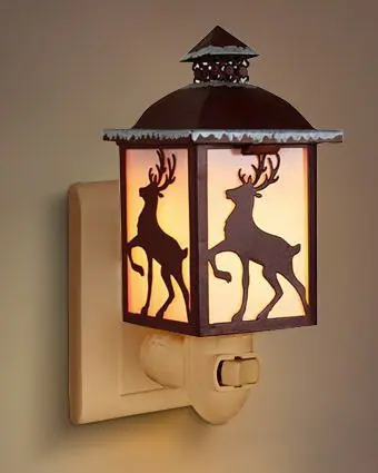 Green-Life metal plug-in wax warmer with cutout pattern, creating ambient light projection while melting wax for decorative fragrance collections.