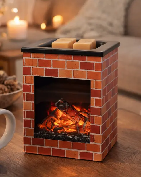 Green-Life metal wax melter lamp with realistic fireplace design, featuring LED flame effect combined with heating module for visual flame ambiance and wax melting, suitable for decorative fragrance collections and retail programs.