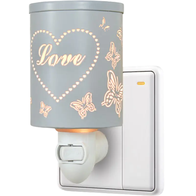 Green-Life metal plug-in wax warmer GF24EP1431E13 with cutout pattern, creating ambient light projection while melting wax for decorative fragrance collections.