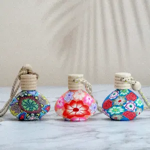 Green-Life glass bottle car air freshener GF24DS207F16 with polymer clay decoration hanging diffuser design, combining artistic design with passive fragrance diffusion in vehicles.