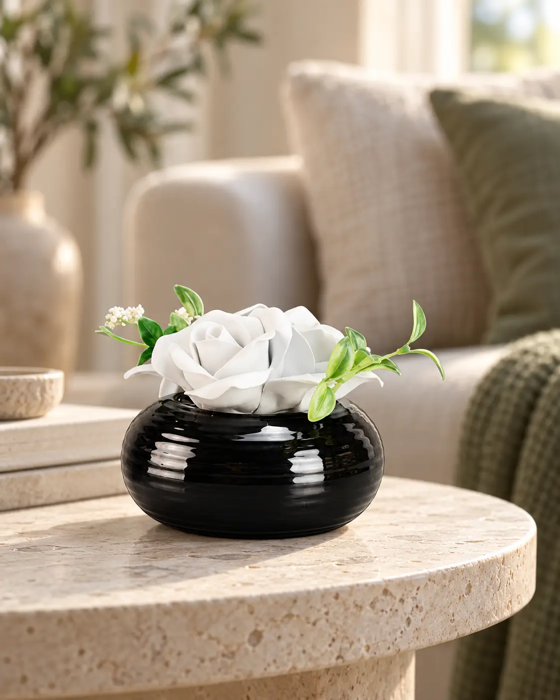 White ceramic flower paired with a black ceramic vessel for a decorative diffuser set.