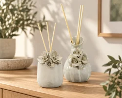 Floral ceramic diffuser vessels with reeds for a coordinated fragrance collection.